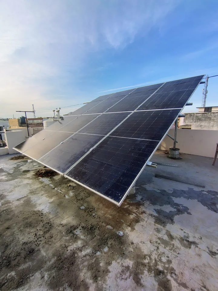 Rows of solar panels mounted on a raised structure on a house roof