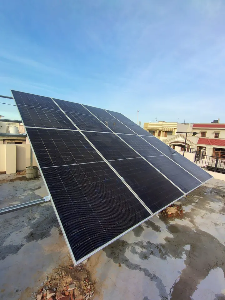 Solar panels mounted on a raised structure on a house roof in Mohali